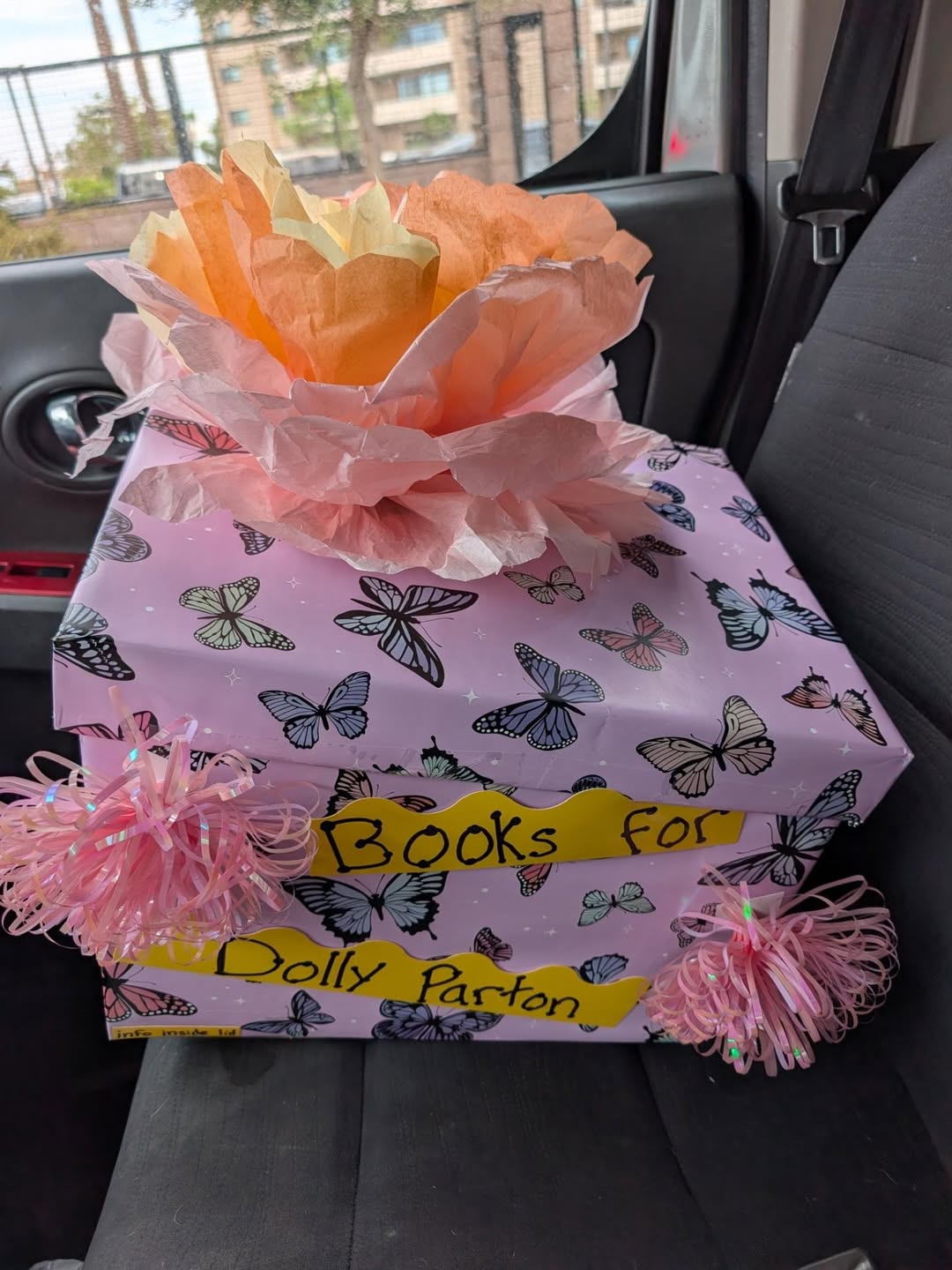 A pink butterfly-covered Books for Dolly donation box on its way to Dust Las Vegas